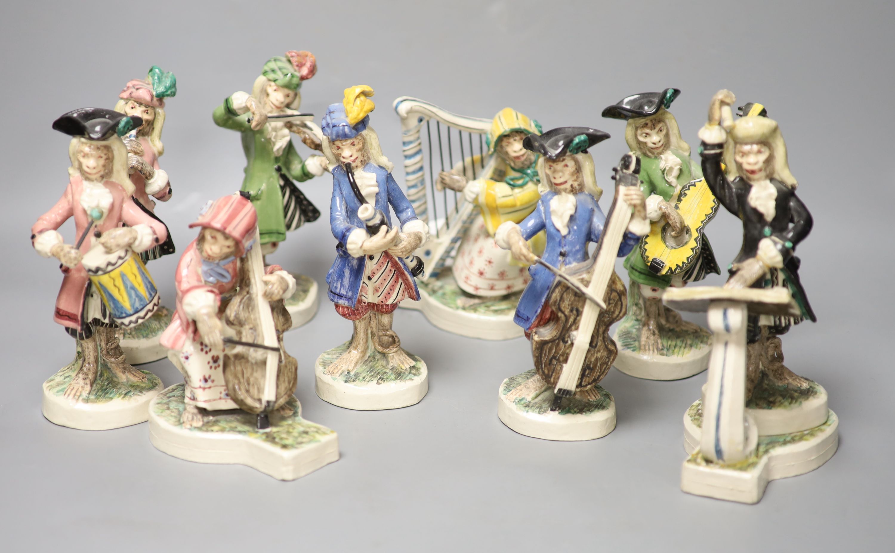 Nine Leslie Ray earthenware monkey bandsmen, height 19cm